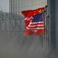 Chinese and US flags flutter outside a corporate building in Beijing in January 2020