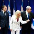 French President Emmanuel Macron (L) is welcomed by Israeli Prime Minister Benjamin Netanyahu (R) and his wife Sara (C) in Jerusalem on Wednesday