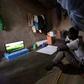 Footy night: Ousmane Kantcho settles down to watch an English Premier League match, thanks to solar energy