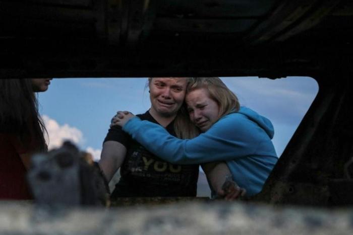Members of the LeBaron family mourn at the site of an attack in Sonora, Mexico where nine women and children were killed