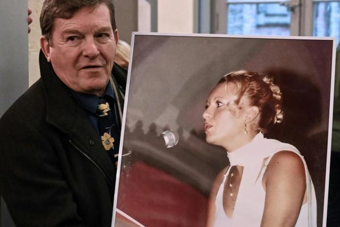 Jacky Kulik holds a portrait of his daughter Elodie who was kidnapped, raped, strangled and her corpse then burned in northern France in January 2002