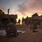 As night draws in, troops draw up their armoured personnel carriers in a square and ready mortars in case of attack