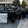Black block protesters march behind a banner reading 'from a spontaneous uprising to the constant struggle' in Athens