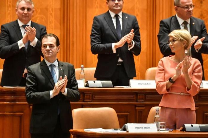 Romanian Prime Minister Ludovic Orban is applauded by members of his cabinet after a vote for a new government at the Romanian Parliament in Bucharest on November 4, 2019