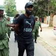 A police officer arrests Zambian musician Chama Fumba, known as as Pilato, in 2017