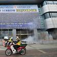 South Korean health officials spray disinfectant in front of the Daegu branch of the Shincheonji Church of Jesus in an attempt to combat the COVID-19 coronavirus outbreak