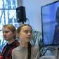 Greta Thunburg watches fellow eco warrior Vanessa Nakate, speaking from Kampala, after she was cropped out of a photo of young activists