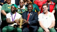 South African President Cyril Ramaphosa holds the Rugby World Cup trophy with Springboks captain Siya Kolisi