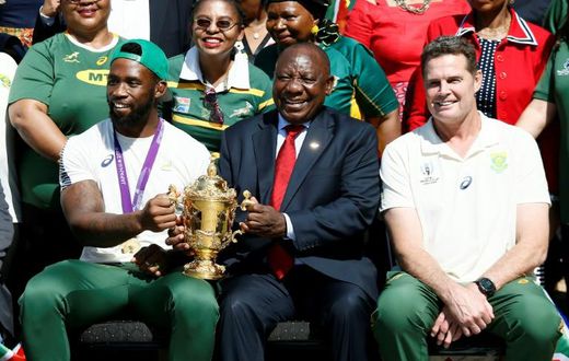 South African President Cyril Ramaphosa holds the Rugby World Cup trophy with Springboks captain Siya Kolisi