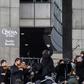 Paris Opera musicians set up on sunlit steps outside the Bastille Opera to play for several hundred passers-by