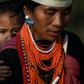 A Naga tribeswoman carrying a child at the end of an overnight ceremony to bless the harvest in Satpalaw Shaung village in Myanmar's Sagaing region