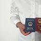 An unidentified Chinese Uighur man in the city of Medina holds his expired Chinese passport (red) and a one-way travel document (blue) issued in its place by the Chinese mission in Saudi Arabia