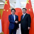 Japan's Prime Minister Shinzo Abe (left) shakes hand with China's President Xi Jinping at the Great Hall of the People in Beijing