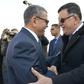 A handout picture released by the official Algeria Press Service (APS) on January 6, 2020 shows Algeria's Prime Minister Abdelaziz Djerad (L) receiving Libya's UN-recognised Prime Minister Fayez al-Sarraj upon his arrival in Algiers