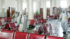 This undated picture released from North Korea's official Korean Central News Agency (KCNA) on February 15, 2020 shows people in protective suits spraying disinfectant at an undisclosed location in North Korea, amid concerns of the COVID-19 outbreak