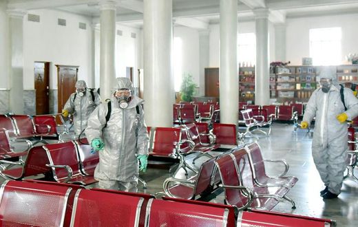 This undated picture released from North Korea's official Korean Central News Agency (KCNA) on February 15, 2020 shows people in protective suits spraying disinfectant at an undisclosed location in North Korea, amid concerns of the COVID-19 outbreak