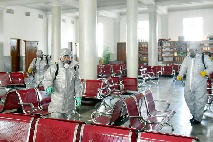 This undated picture released from North Korea's official Korean Central News Agency (KCNA) on February 15, 2020 shows people in protective suits spraying disinfectant at an undisclosed location in North Korea, amid concerns of the COVID-19 outbreak