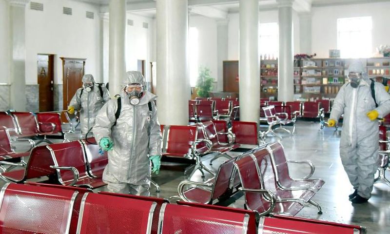 This undated picture released from North Korea's official Korean Central News Agency (KCNA) on February 15, 2020 shows people in protective suits spraying disinfectant at an undisclosed location in North Korea, amid concerns of the COVID-19 outbreak