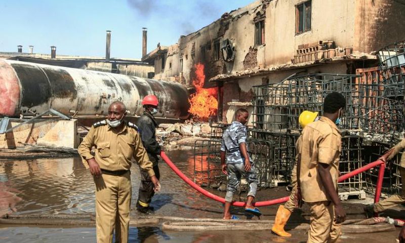 Sudanese firefighters tackle the deadly blaze in a north Khartoum ceramics factory