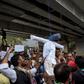 Demonstrators from the National Congress Party hang and beat a dummy of a rapist as they protest against sexual violence