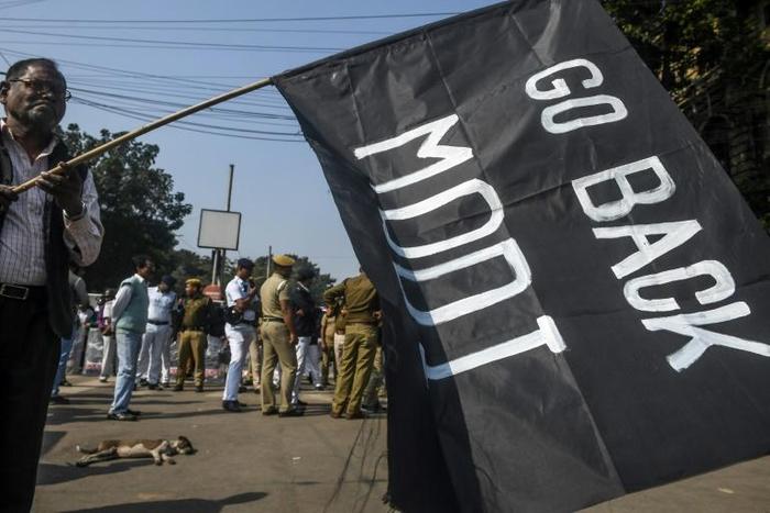 Protesters in Kolkata brandished black flags, considered an insulting gesture in Indian society
