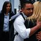 Hugo Pinto Exposto (C), the son of Maria Elvira Pinto Exposto (not pictured), reacts after a Malaysian court overturned her death sentence for drug trafficking and ordered her release
