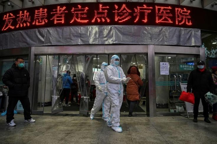 Medical staff outside  the Wuhan Red Cross Hospital, where resources are stretched to the limit