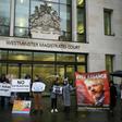 Supporters wave banners outside the London court where WikiLeaks founder Julian Assange was testifying about how he was spied on inside the Ecuadoran embassy