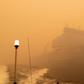 The Royal Australian Navy ship HMAS Choules sails amid heavy smoke off the coast of Mallacoota, Victoria state to assist in bushfire relief efforts