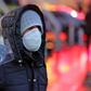 An Iranian street vendor sells protective masks in the capital Tehran