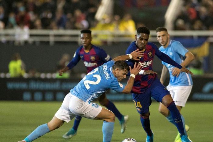 Close contact: Barcelona defender Junior Firpo (right) tussles with Ibiza defender Kike Lopez