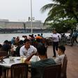 Diners have lunch in the foreground of the Westerdam cruise ship in Sihanoukville