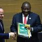 Handover: Outgoing AU chair Egyptian President Abdel Fattah al-Sisi, left, passes the baton to South African President Cyril Ramaphosa. Ramaphosa says settling the conflicts in Libya and South Sudan will be a priority of his tenure