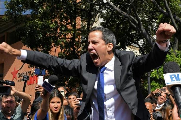 Venezuelan opposition leader and self-proclaimed acting president Juan Guaido shouts on his way to the National Assembly, in Caracas, on January 7, 2020, where he claimed the speaker's chair