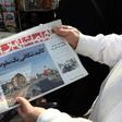An Iranian holds a newspaper with a picture of the debris of the Ukrainian plane that crashed in Tehran on January 8, 2020, outside a news stand in the Islamic republic's capital