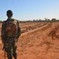 A Nigerien soldier looks at the graves of military personnel killed in a jihadist attack ahead of the arrival of G5 Sahel leaders on December 15, 2019