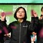 Taiwan President Tsai Ing-wen (C) joins hands with Vice President-elect William Lai (L) and current Vice President Chen Chien-jen at campaign headquarters in Taipei on January 11, 2020; she was re-elected in a lopsided vote seen as a blow to China