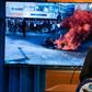 US Secretary of State Mike Pompeo speaks alongside a photograph of demonstrations in Iran