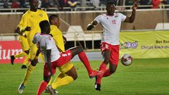 Peniel Mlapa (L) and Kodjo Fo-Doh Laba of Togo and Victor Wanyama (R) and Stanley Okumu of Kenya seek possession during a drawn Cup of Nations qualifier