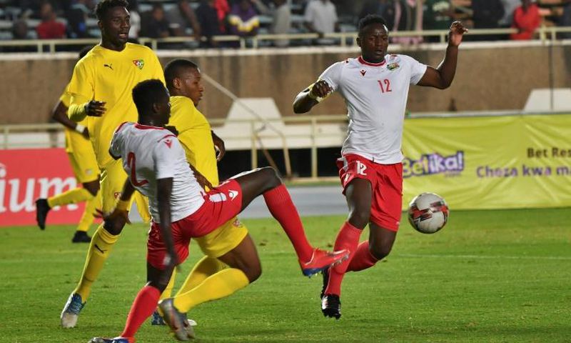 Peniel Mlapa (L) and Kodjo Fo-Doh Laba of Togo and Victor Wanyama (R) and Stanley Okumu of Kenya seek possession during a drawn Cup of Nations qualifier