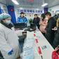 Experts say China is taking a starkly different approach to handling a new virus outbreak compared with the 2002-03 SARS crisis