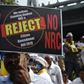 A protester holds a placard during a demonstration against India's new citizenship law in Mumbai