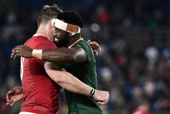 Captain Siya Kolisi (R) hugs teammate Duane Vermeulen, wearing a Wales shirt, after a 19-16 World Cup semi-final victory last Sunday