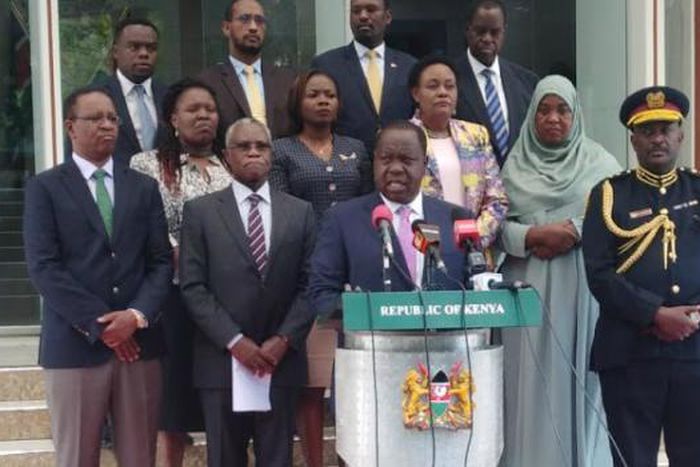 Interior CS Fred Matiang'i, Inspector General Hillary Mutyambai and NCIC led by Chairman Samuel Kobia addressing the media at Harambee House. Fatuma (standing behind Hillary Mutyambai) passed on Sunday, December 29 after collapsing at a wedding