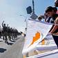 People in Nicosia wave flags during a military parade marking the 59th anniversary of Cyprus' independence from British colonial rule in October 2019