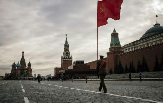 Russian Communist party activists and supporters march towards Lenin's Mausoleum for a ceremony on Red Square in Moscow