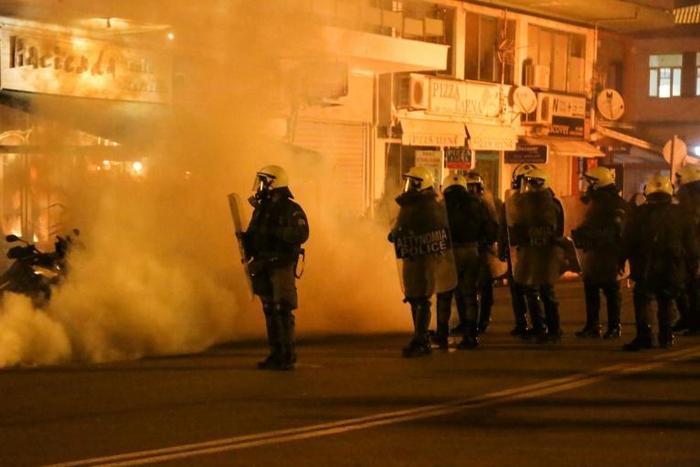 Riot police use tear gas during clashes with demonstrators protesting against the construction of controversial new migrant camps on Lesbos island