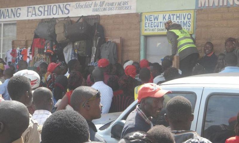 File image of a crowd outside a lodging where a man was caught engaging in sexual acts with a married woman