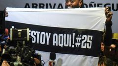 Togo forward Emmanuel Adebayor holds up a message to his new fans at Paraguay champions Olimpia on his arrival in Asuncion