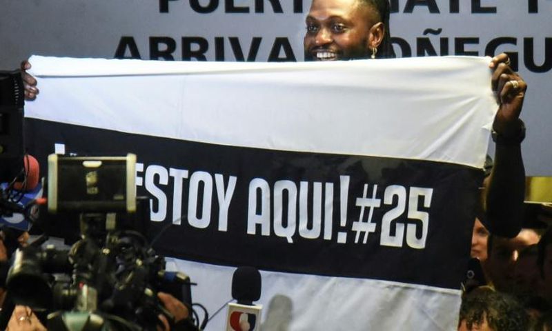 Togo forward Emmanuel Adebayor holds up a message to his new fans at Paraguay champions Olimpia on his arrival in Asuncion
